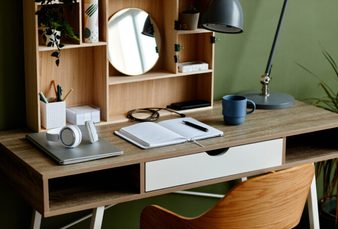 Background image of students workplace with wooden table and notebook set up for home education and studying